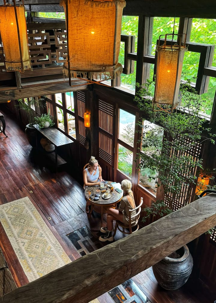 An overhead view of two girls sitat a cafe table.